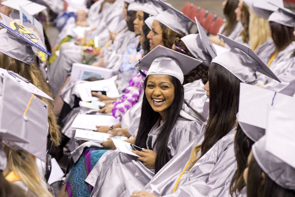 A soon-to-be graduate smiles during the graduation ceremony.