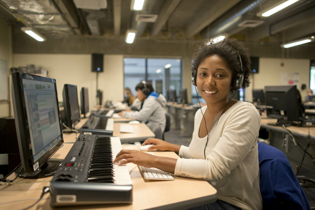 Students work on keyboards and computers in the Music Lab.