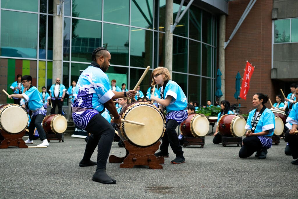 Students drum on campus.