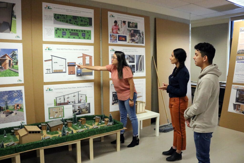 Interior design students display presentations.