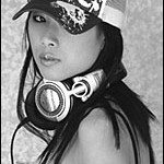 Young Asian female in baseball cap and headphones