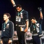 Two Black athletes showing a "Black Power" salute on the medal podium at the 1968 Olympics