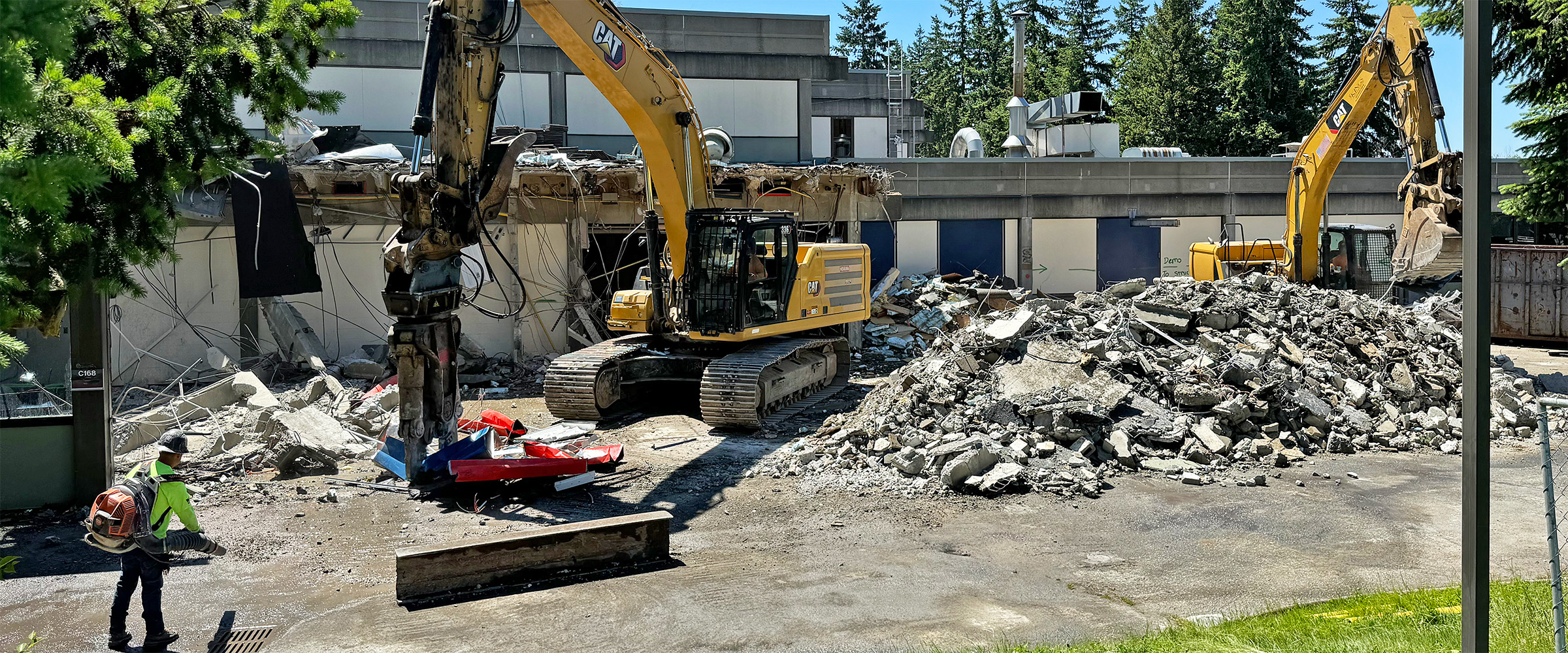 picture of construction equipment demolishing part of building C