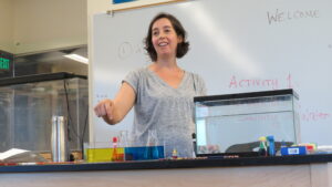 science faculty is performing a demonstration at the front of the classroom