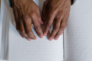 A student reading braille