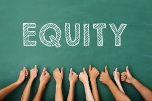 Picture showing the word Equity with hands of different skin color