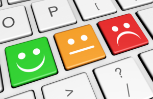 Keyboard with three buttons. A smiley face, a straight face and a frowning face