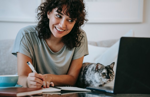 Picture of student represents online advising using a laptop computer and is part of the page design.