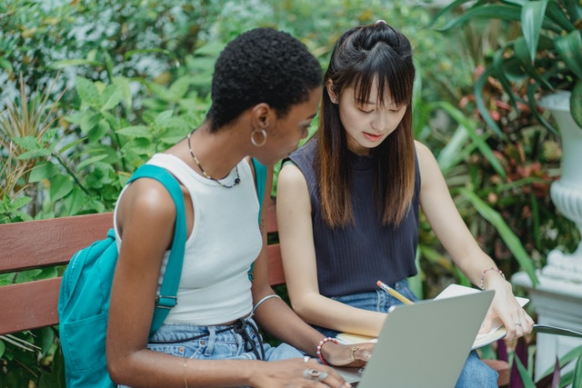 Picture of students is decorative only and part of the page design.