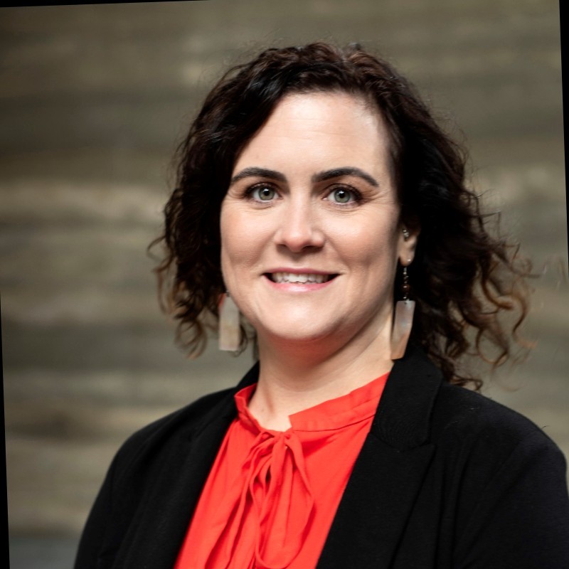 Heather Woods wearing salmon colored shirt and black blazer