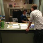 Two people standing at the Bellevue College Transportation Desk