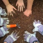 Circle of hands in the dirt