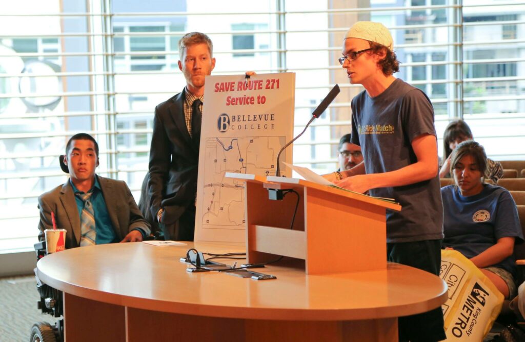 BC Metro Cuts Meeting speak and hold signs