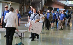 Bellevue College group walks into Metro Cuts Meeting in Bellevue