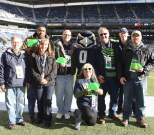 Ray White receives the Champions of Sustainability Award on behalf of Bellevue College at Quest Field with a group of other recipients.