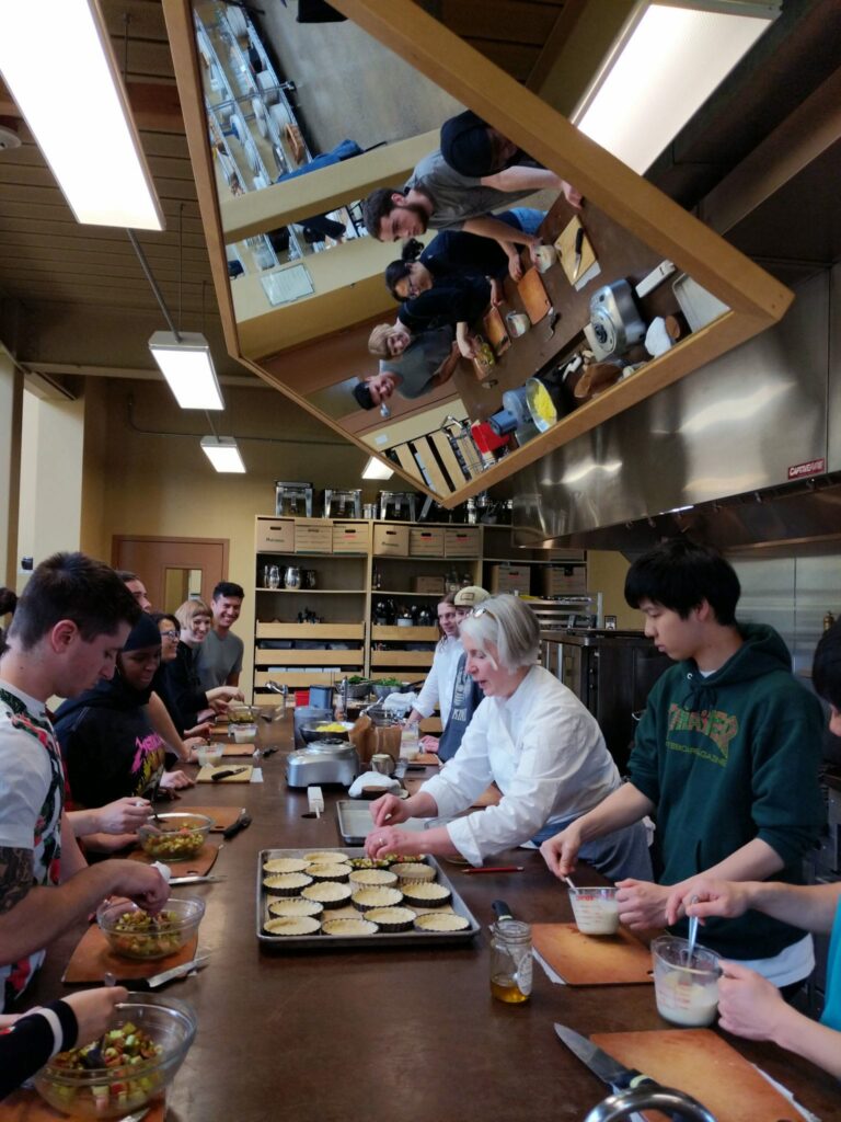 students and employee of 21 acres farm cooking during a field trip