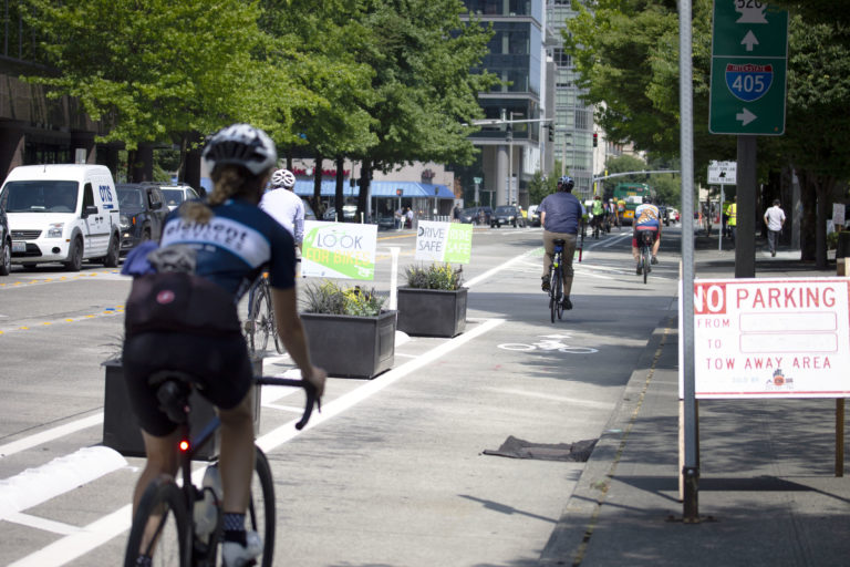 Someone biking down the new bike lane in Bellevue during it's opening