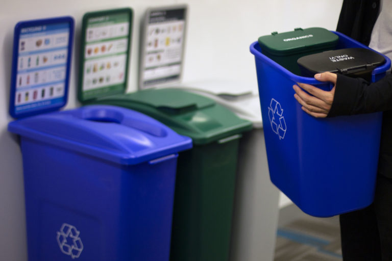 The MiniMax being sorted into trash, recycle, and compost bins