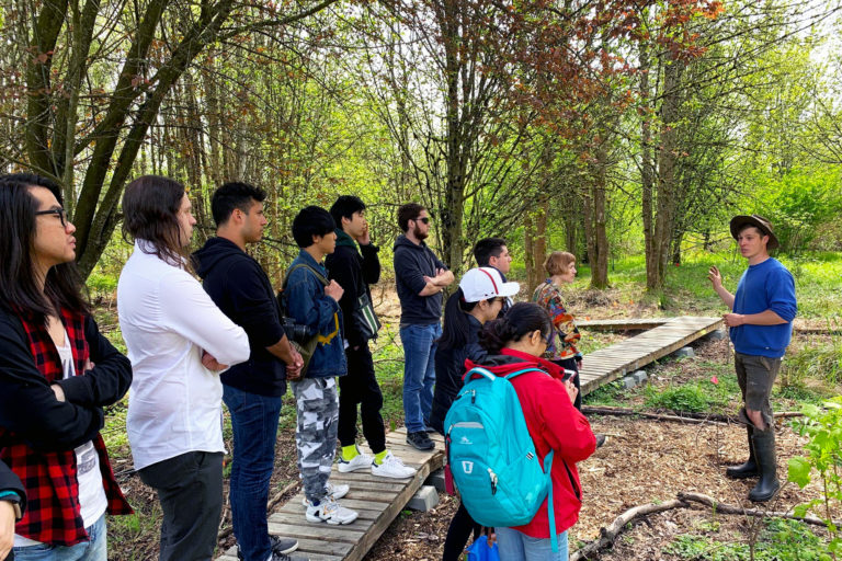 A walking tour of 21 acres with a group of students during a sustainability field trip.