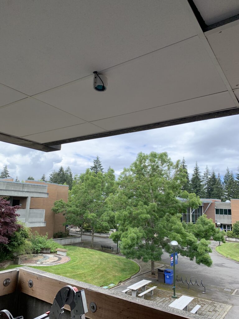 air sensor mounted on ceiling outside B building, overlooking courtyard.