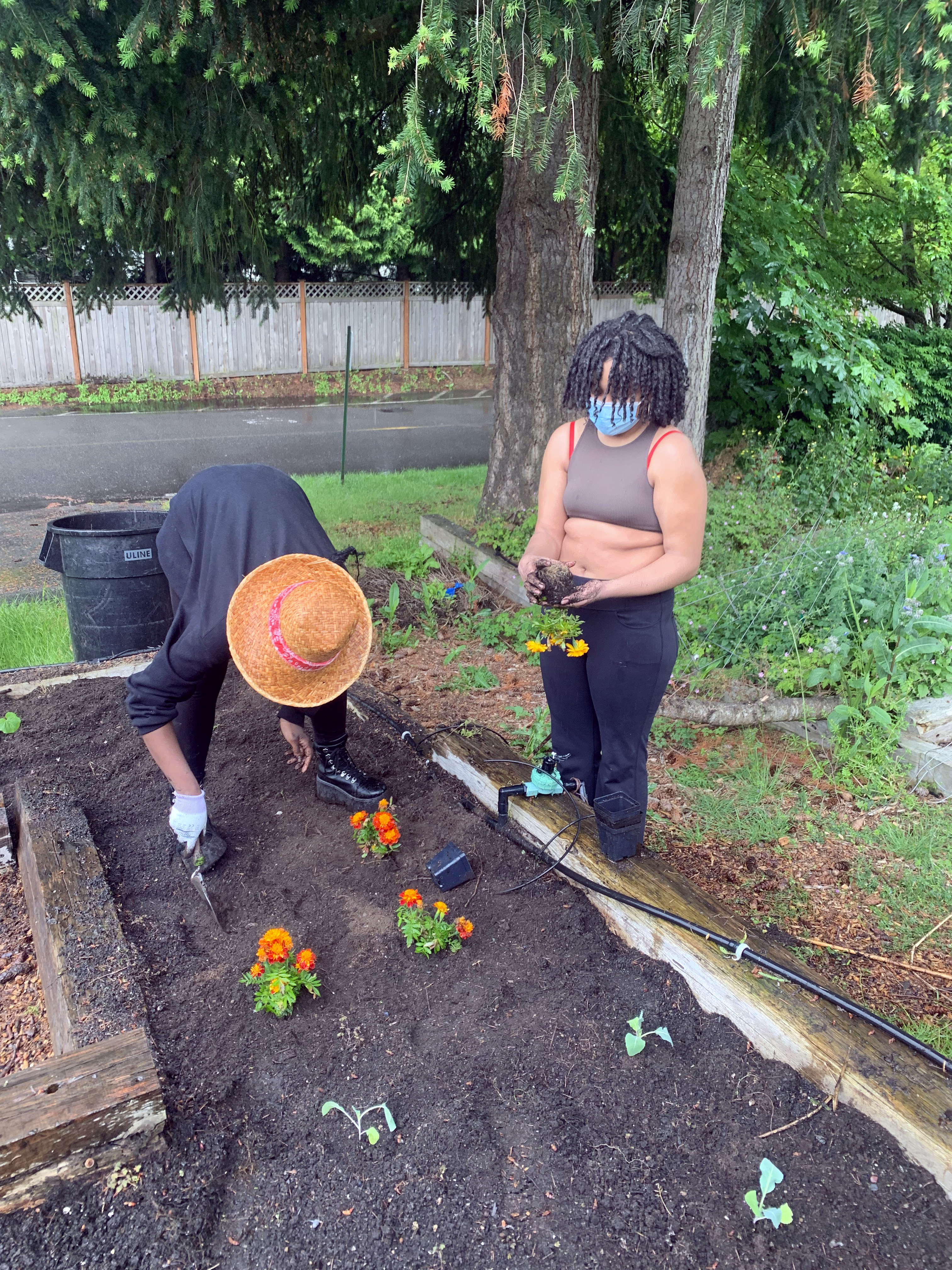 two students working hard in the garden