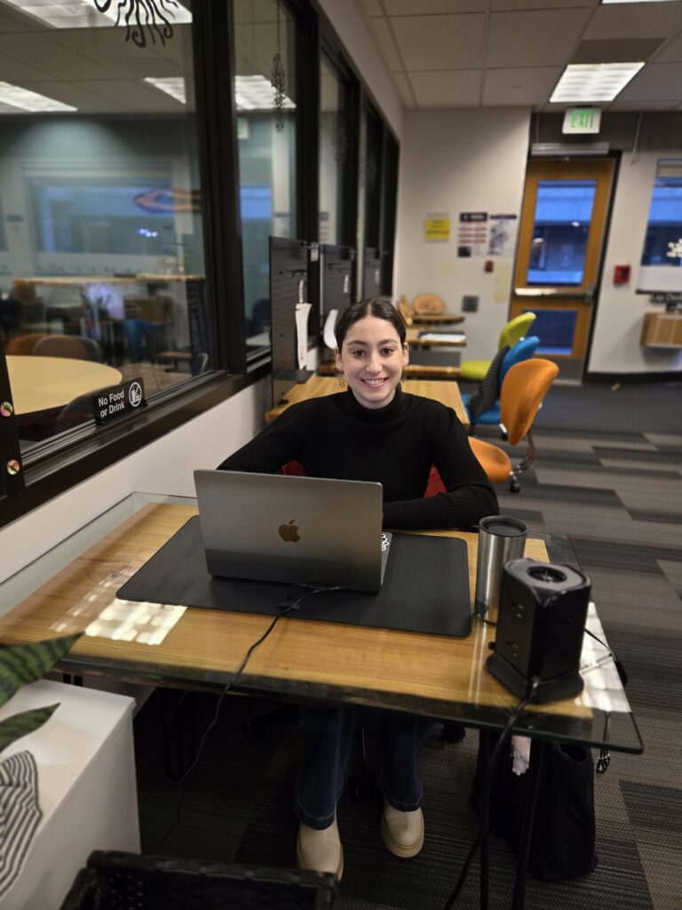Tutor at Writing Lab front desk to welcome visitors into the space.