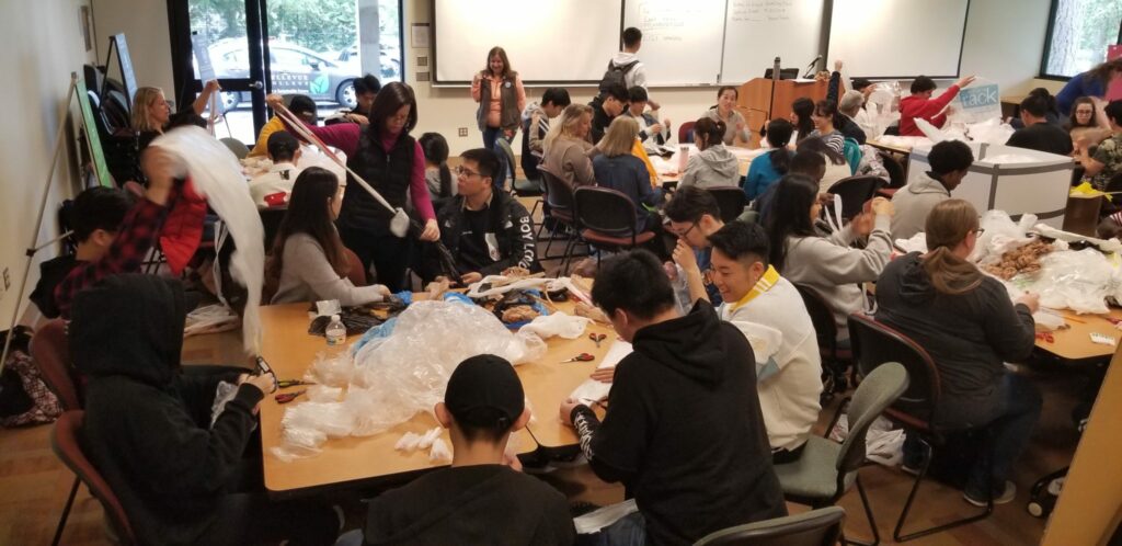 Group of students and faculty working with plastic