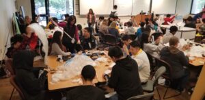 Group of students and faculty working with plastic