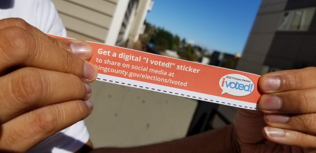 Photo of person holding red ballot stub 