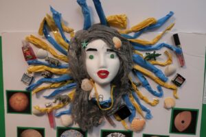 Sculpture of woman with hair made of plastic and other material found in the ocean