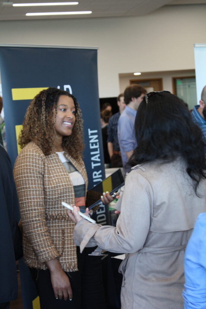 A employer speaking to a student at a Job and Networking Fair