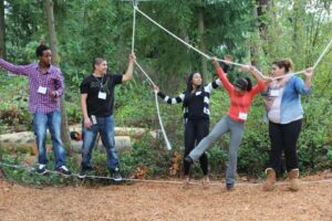 Students balancing on rope during a rope challenge course
