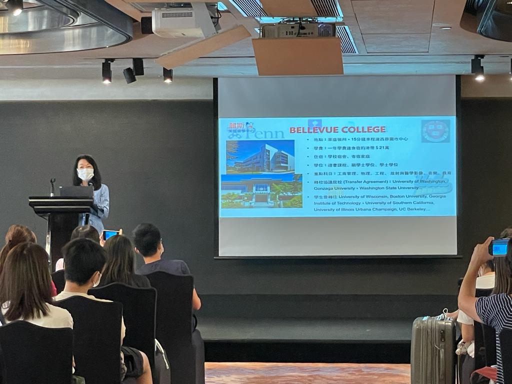 Presentation at Litz recruitment fair by representative for Bellevue College. Someone standing at a podium with a slide about Bellevue College projected behind them.
