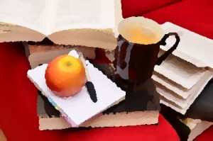 Image of books, notebook, pen, apple, and cup of coffee