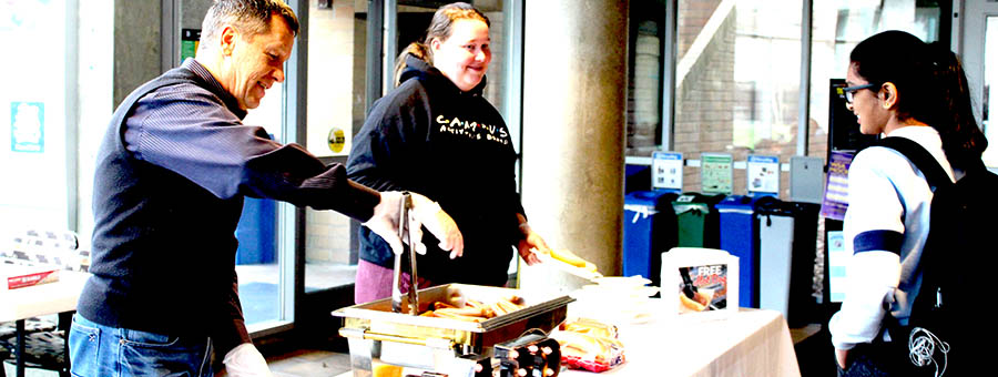 Handing out hotdogs during de-stress event