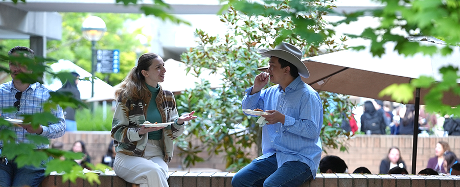 Students and alumni enjoying a catered meal at an Alumni event.