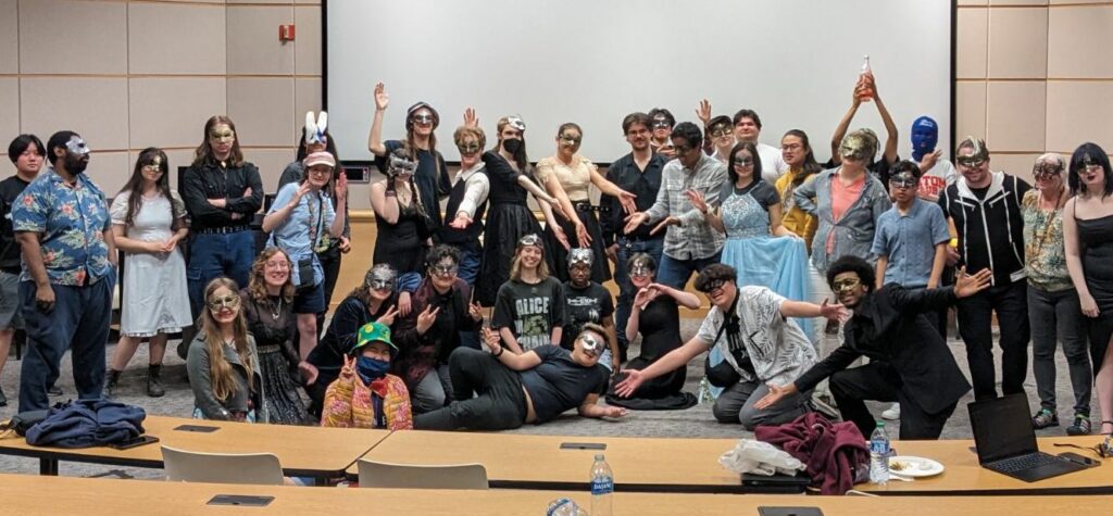 Group photo -- everyone's in costume or masks -- of about two dozen Stage Fright Drama Club members.