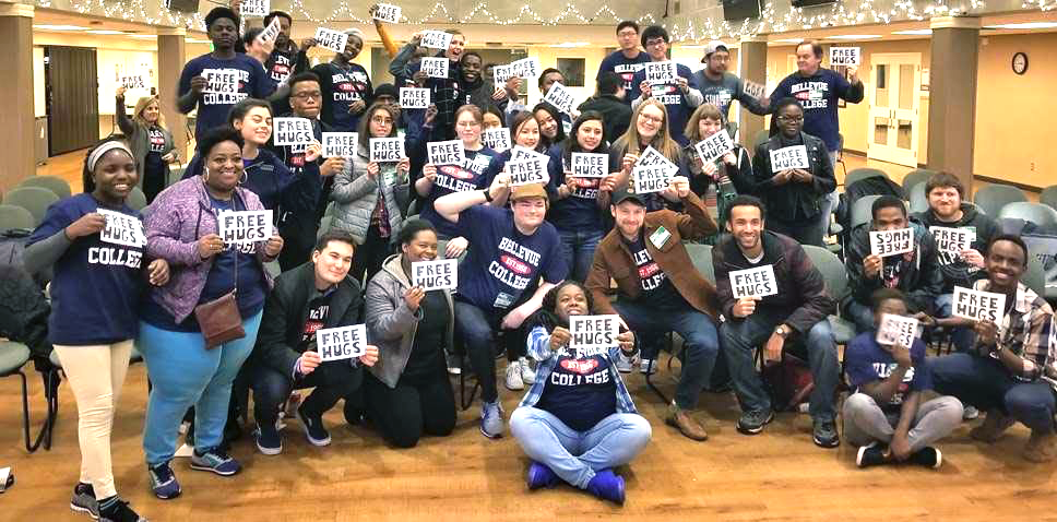 Students holding signs for "Free Hugs" at Leadership Retreat