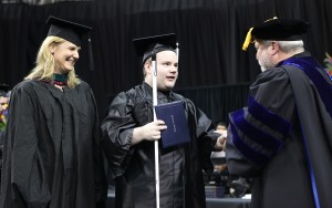 OLS student Chris Taylor receives his diploma