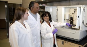 Dr. Bangera works with students in the laboratory