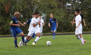 A Bellevue College player advances the ball in a men's soccer match against South Puget Sound