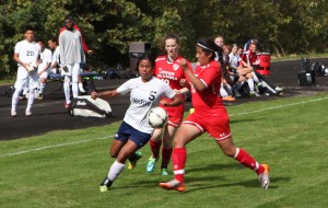 A Bellevue College player battles for the ball in a women's soccer match against Lower Columbia