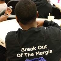 The back of a BOOM participant's shirt that says Break Out Of The Margin