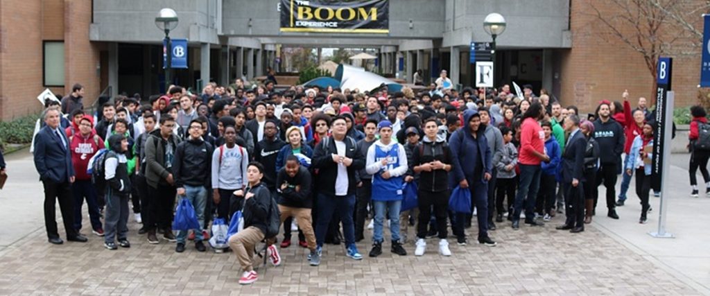 A group of Boom experience attendees in front of the BC fountain