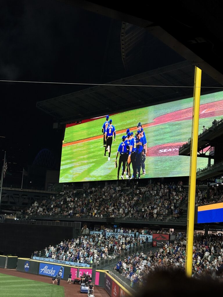 Watching the game on the jumbotron.