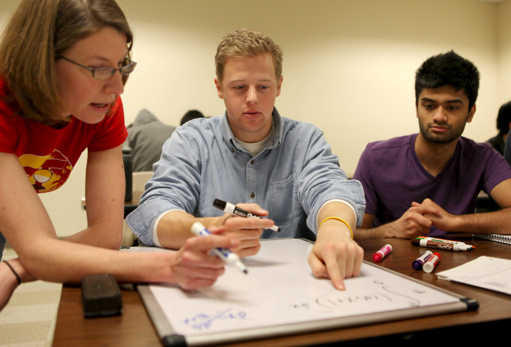 students working with professor on project