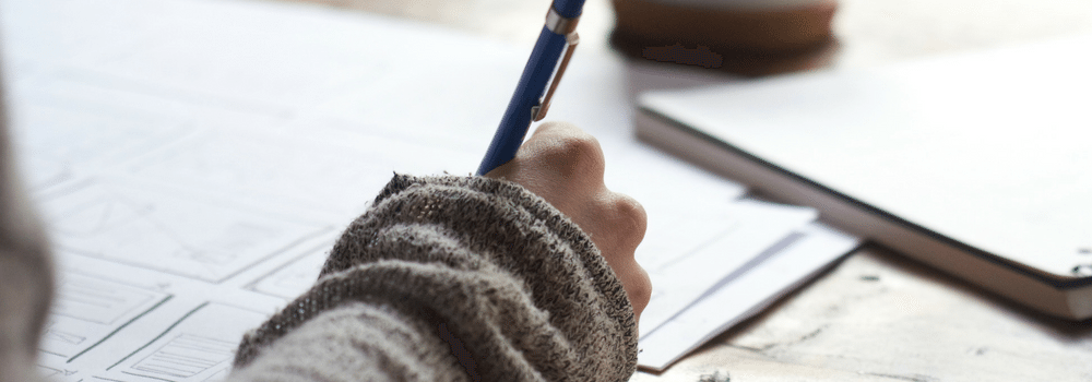 Stock photo of close up of hand writing notes