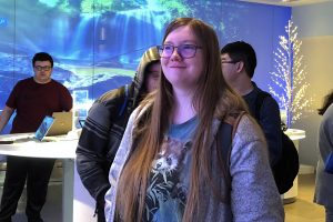 OLS Student smiles and obsewrves the Microsoft Museum