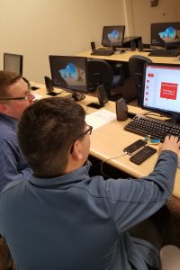 OLS Student working wtih Instrcutor on Computer