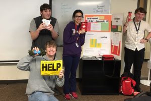 Students show off their emergency preparedness table share night table display